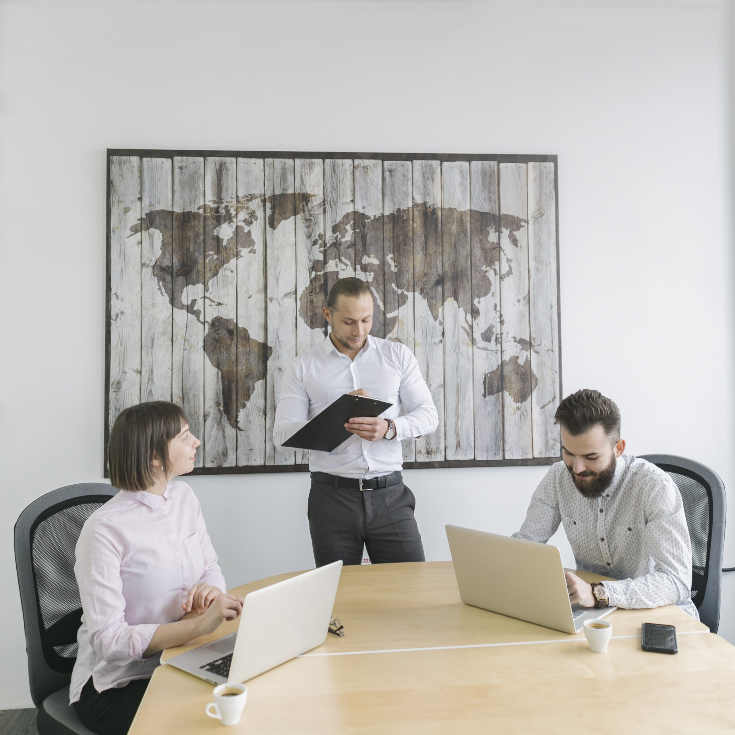 Executives in a modern conference room discussing AI strategy with charts and graphs displayed on a screen.