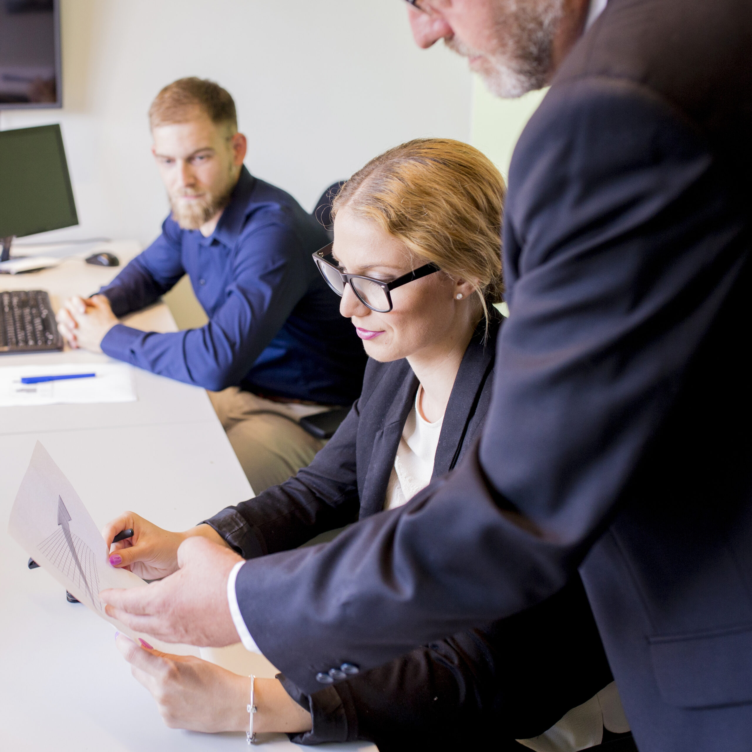 A consultant presenting a strategic roadmap to a business team in a modern office.