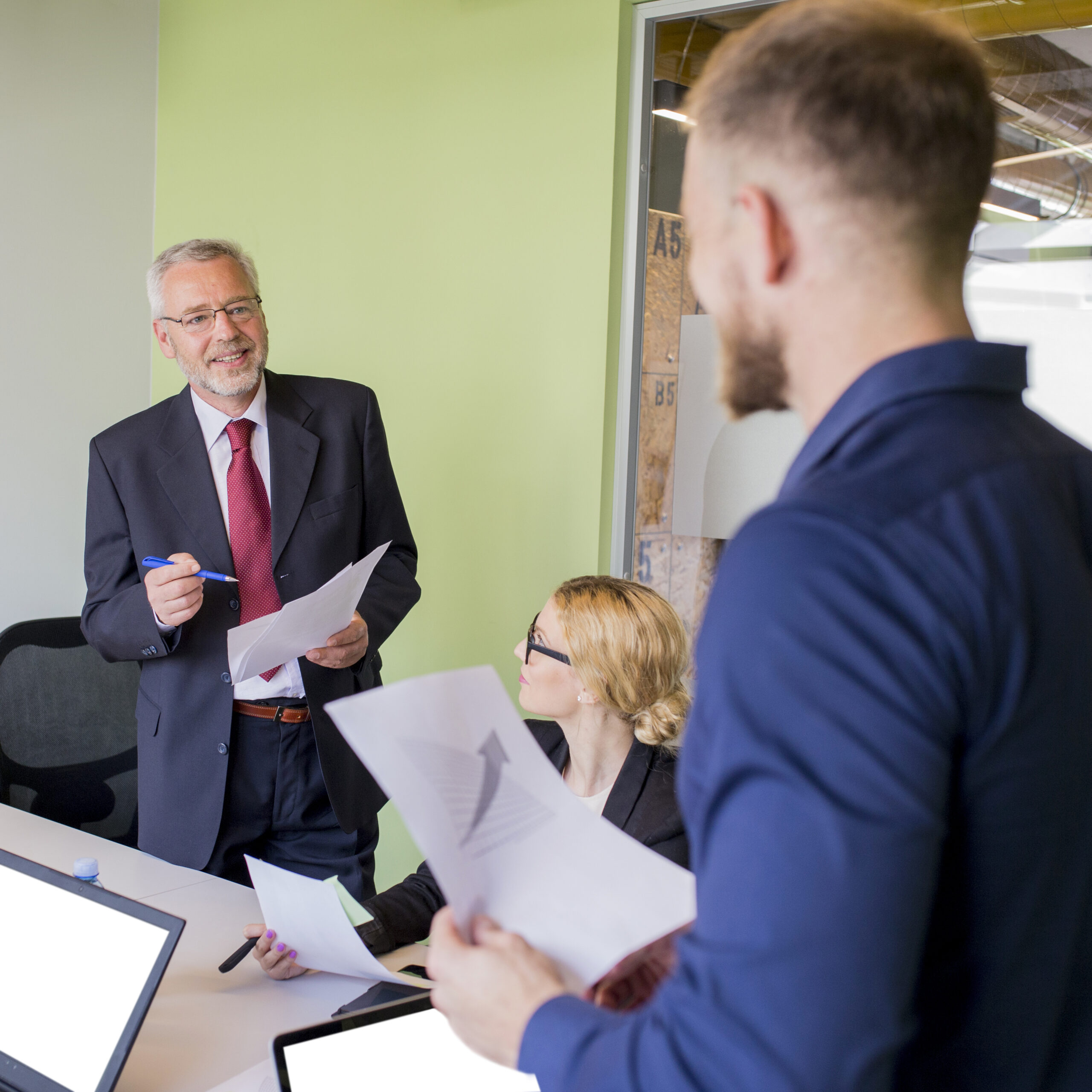 A diverse team of consultants in a bright conference room discussing data and technology infrastructure.